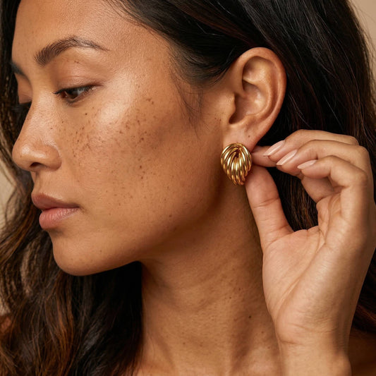 femme portant des Boucles d’oreilles dorées en forme de feuille en acier inoxydable – Lidiar Collection